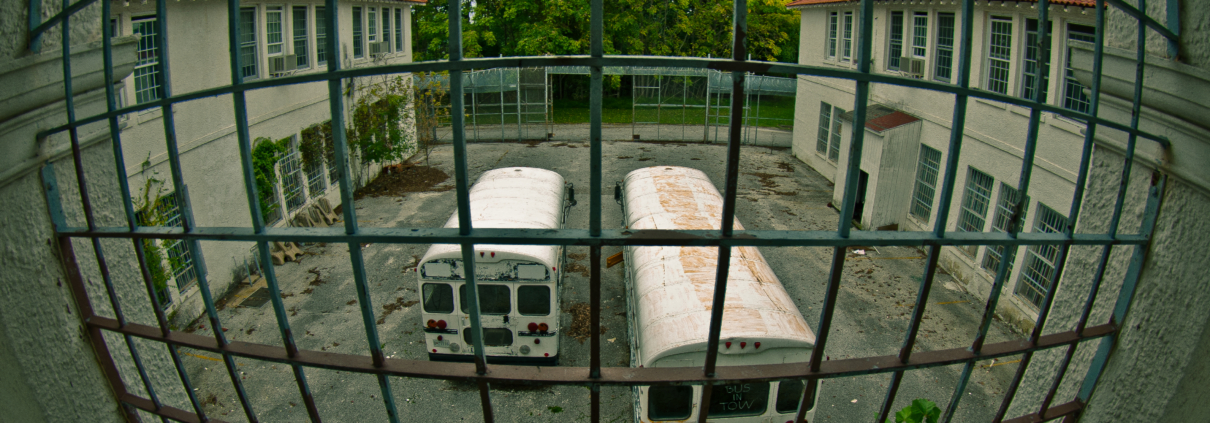 Two busses at a penitentiary